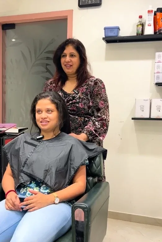 Hair stylist working with a client in the salon at Chetana's Beauty Lounge
